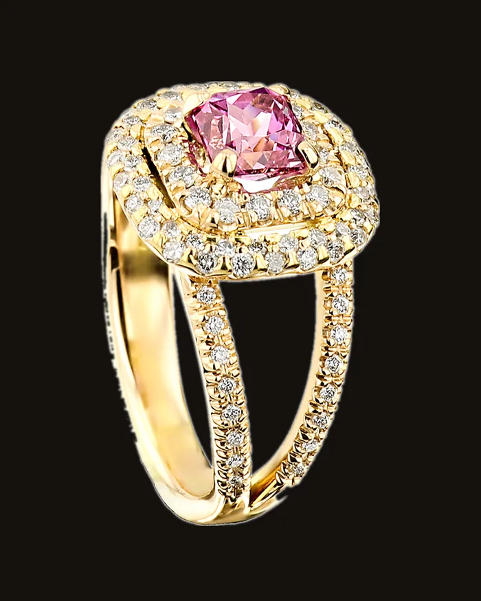 Pink sapphire in a double halo of diamonds on a split diamond band, yellow gold